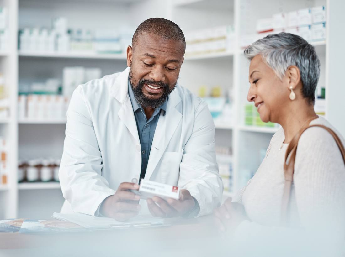 A pharmacist helping a member at the pharmacy counter