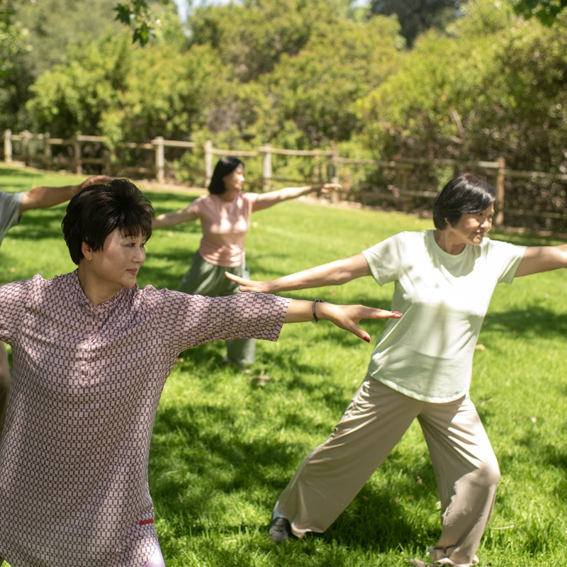 A caregiver supporting a senior member outdoors
